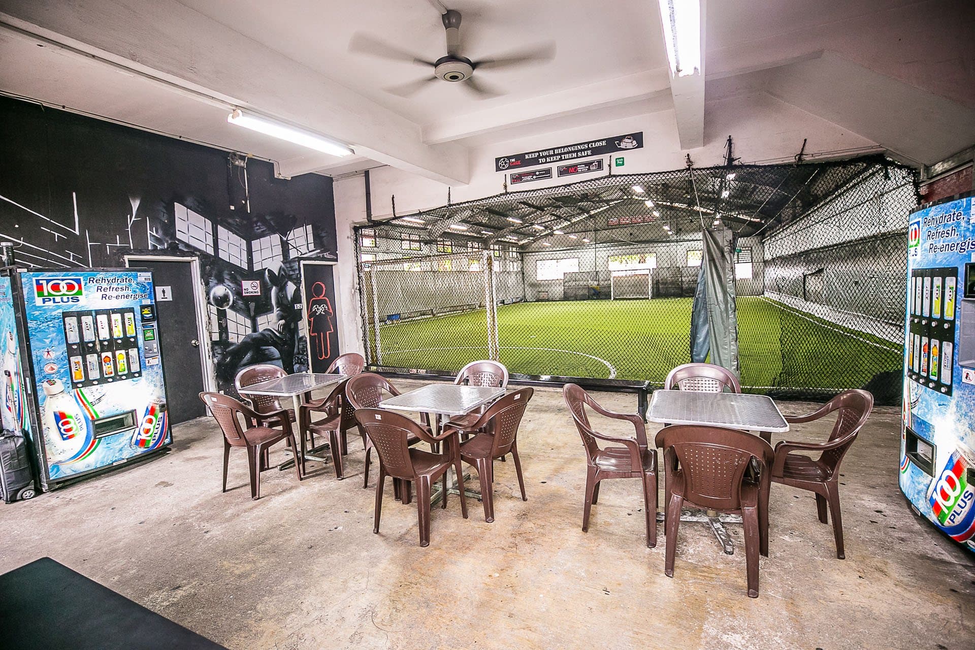 Indoor sitting area at The Cage @ Kallang with view of an arena